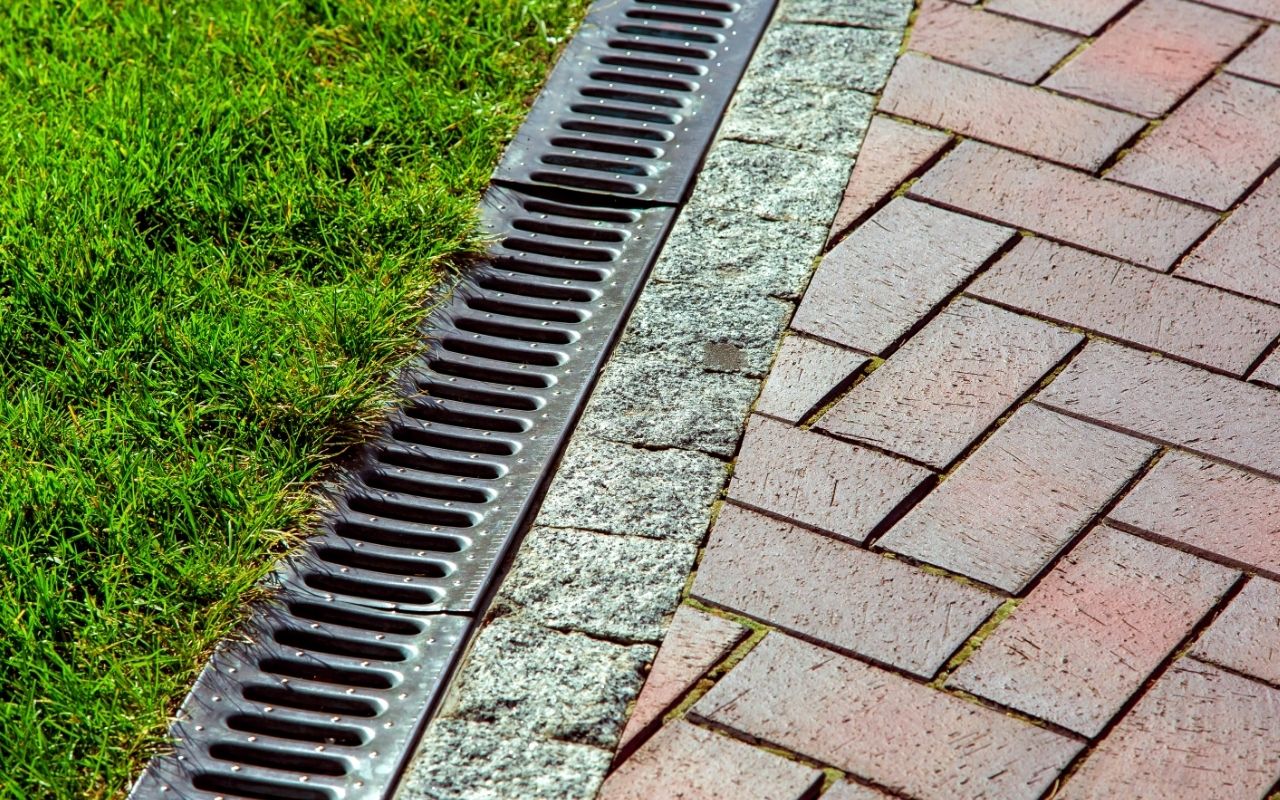 Technician improving backyard drainage system
