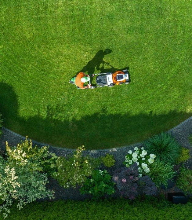 Landscaping maintenance crew pruning shrubs and refreshing mulch in a Bainbridge Island, WA yard